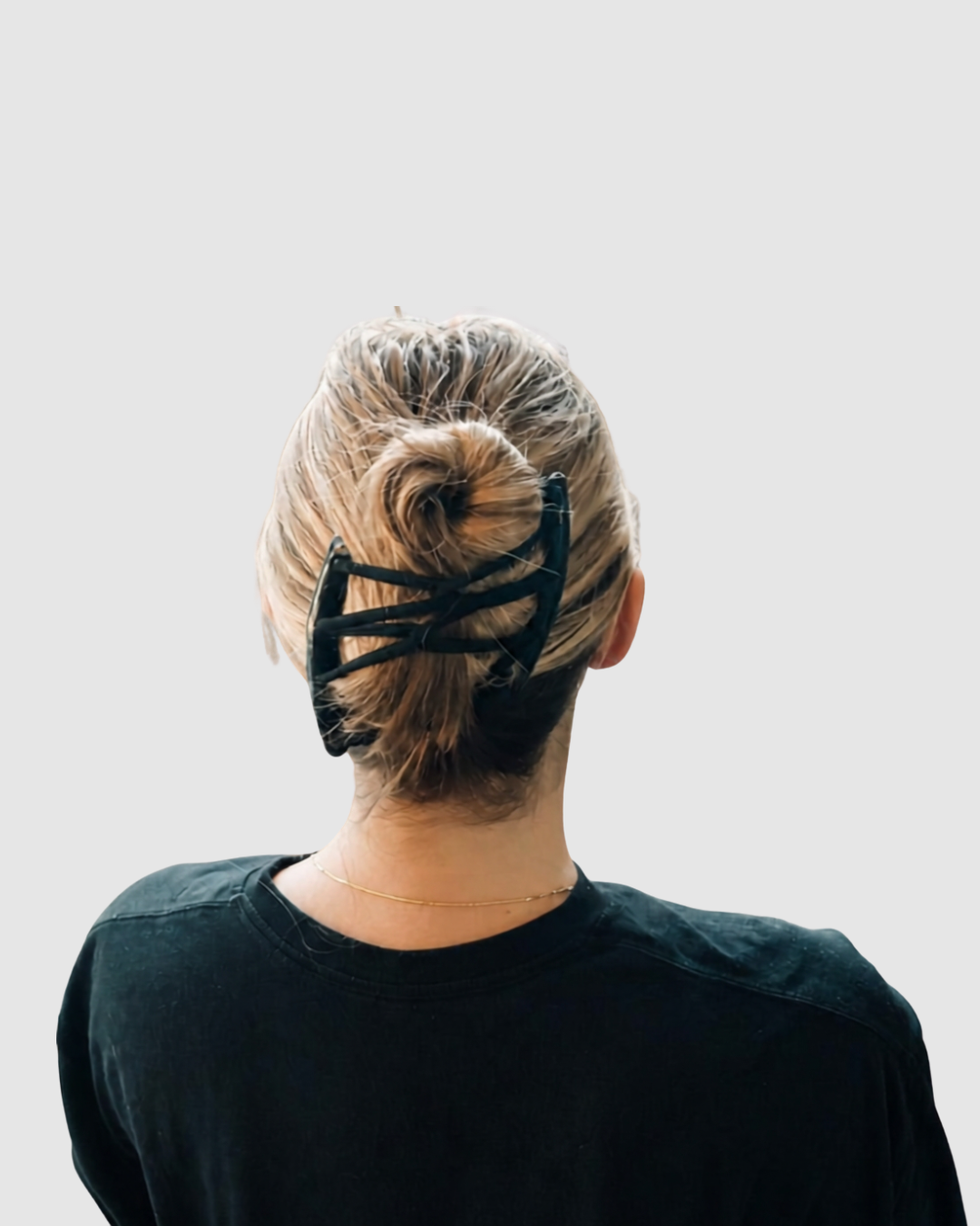 Midnight Black Halo Comb holding a full bun, seen from behind