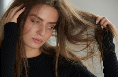 Woman with stressed, damaged hair at the roots