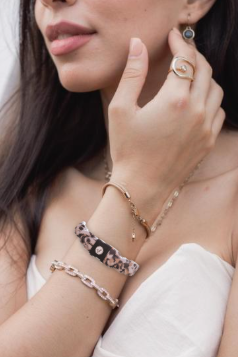 Versa Band worn on the wrist alongside other bracelets