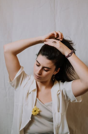 Woman pulling Versa Band off her wrist to tie up her hair