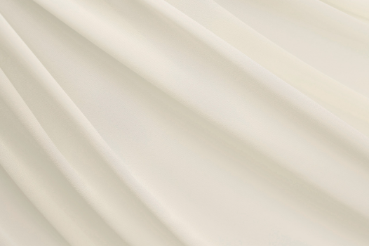 Close-up of soft cream-colored nylon fabric folds
